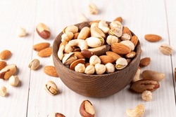 Healthy Mix Nuts On Wooden Background. Almonds, Hazelnuts, Cashews, Peanuts, Pistachios, Brazilian Nuts