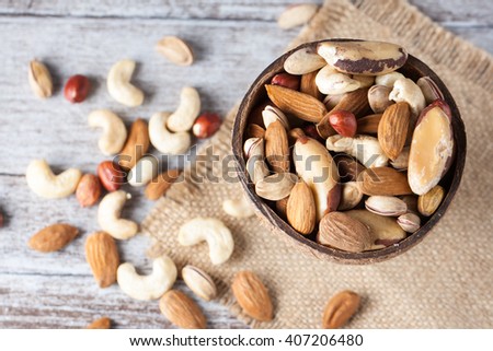 Healthy mix nuts on wooden background. Almonds, hazelnuts, cashews, peanuts, brazilian nuts
