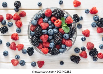 Healthy mixed fruit and ingredients with strawberry, raspberry, blueberry, blackberry from top view