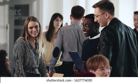 Healthy Multiethnic Workplace Atmosphere. Happy Young Business People Communicate At Comfortable Modern Loft Office.