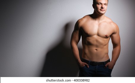 Healthy Muscular Young Man. Isolated On Black Background