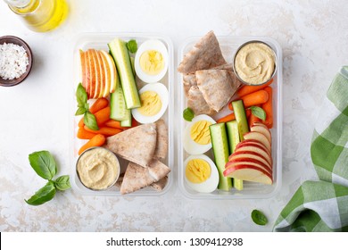 Healthy And Nutricious Lunch Or Snack Boxes To Go With Hummus And Pita, Eggs And Vegetables