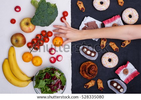 Healthy nutrition concept. Fruits and vegetables vs sweets and unhealthy food.