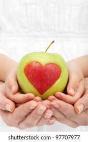 Healthy Nutrition Concept - Hands Holding Apple With Heart Cutout