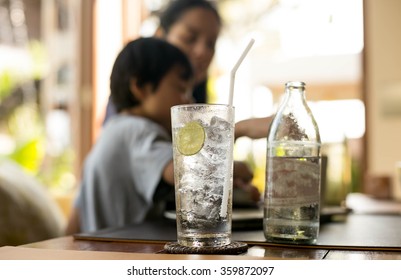 Healthy Nutrition Of Drinking Water With Lemon And People In Blur Background