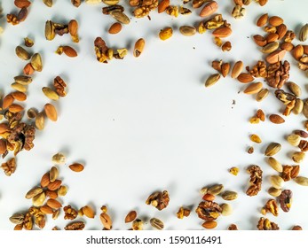 Healthy and nutritious organic colorful nut mix presenting a healthy diet out on the corners forming a random frame with empty white space to fill - Shutterstock ID 1590116491