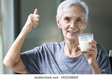 Healthy Old Elderly Grandmother Thumbs Up For Delicious Fresh Milk Drink During Breakfast,happy Smiling Asian Senior Woman Drinking Warm Milk Or Nutritional Supplements From The Glass,health Care