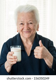 Healthy Old Woman Holding A Glass Milk 