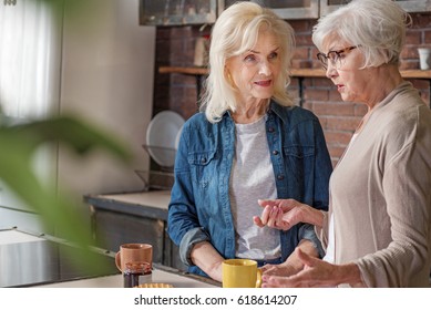 Healthy old women talking in cook room