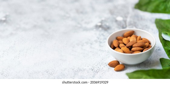 Healthy Organic Almond Nut Super Food In A Ceramic Bowl With Copy Space Banner Background.