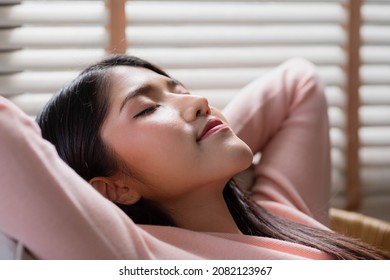 Healthy Peaceful Lady Relaxing On Comfy Sofa Dozing Feel Worry Free At Home Lounge Alone, Taking Deep Breaths Of Fresh Air While Holding Hands Behind Head.