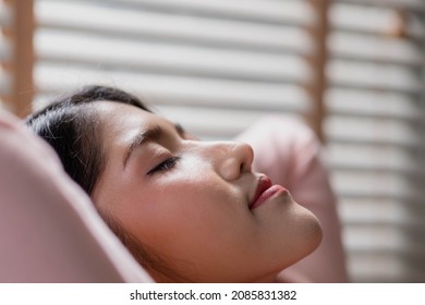 Healthy Peaceful Lady Relaxing On Comfy Sofa Dozing Feel Worry Free At Home Lounge Alone, Taking Deep Breaths Of Fresh Air While Holding Hands Behind Head.