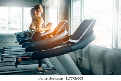 Healthy People Running On Machine Treadmill At Fitness Gym, Work Out Concept.Picture Of People Doing Cardio Training On Treadmill In Gym.