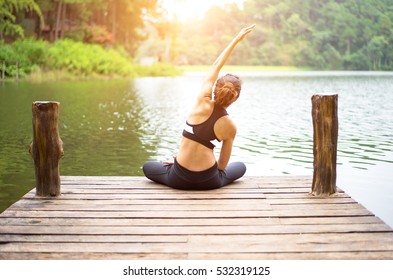 Healthy Person Woman Lifestyle Balanced Body Practicing Meditate And Energy Fit Yoga Relax And Spirit On The Bridge In Morning The Nature.  Healthy Concept
