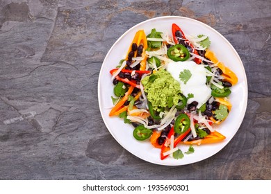 Healthy, Plant Based Bell Pepper Nachos. Top View On A Dark Slate Background. No Carb, Vegetarian Diet.