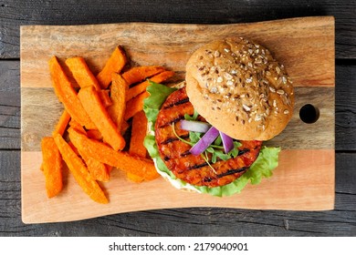 Healthy, Plant Based Burger With Sweet Potato Fries. Top View Against A Wood Background.