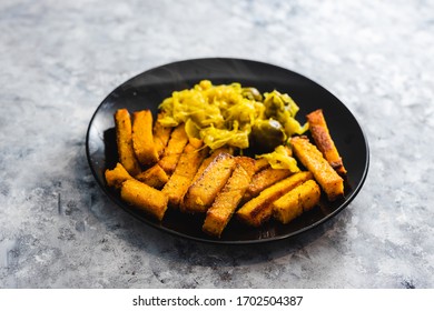 Healthy Plant-based Food Recipes Concept, Vegan Polenta Chips And Sauerkraut With Brussel Sprouts