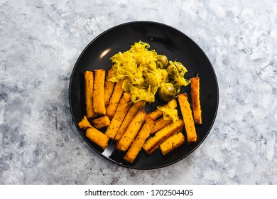 Healthy Plant-based Food Recipes Concept, Vegan Polenta Chips And Sauerkraut With Brussel Sprouts