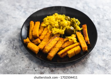 Healthy Plant-based Food Recipes Concept, Vegan Polenta Chips And Sauerkraut With Brussel Sprouts