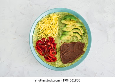 Healthy Plant-based Food Recipes Concept, Vegan Version Fo The Viral Layered Tortilla Wrap Hack With Red Peppers Grated Dairy-free Cheese Avocado And Refried Beans