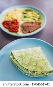 Healthy Plant-based Food Recipes Concept, Vegan Version Fo The Viral Layered Tortilla Wrap Hack With Red Peppers Grated Dairy-free Cheese Avocado And Refried Beans