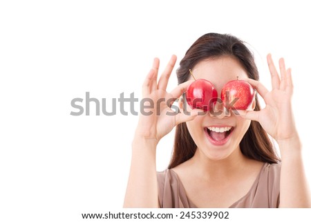 healthy and playful woman covering her eyes with two red apples, brown dress for summer and spring season