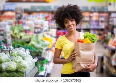Healthy Positive Happy African Woman Holding A Paper Shopping Bag Full Of Fruit And Vegetables
