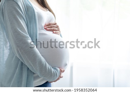 Similar – Image, Stock Photo Pregnant woman holding her tummy