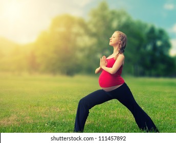 healthy pregnant woman doing yoga in nature outdoors - Powered by Shutterstock