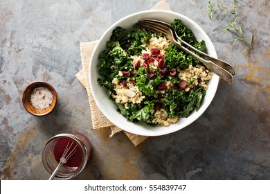 Healthy raw kale and quinoa salad with cranberry and almonds
