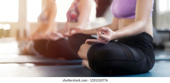 Healthy and Relaxation concept. Group of asian women practicing yoga pose or pilates on yoga mat. Copy space and Horizontal photo banner background.