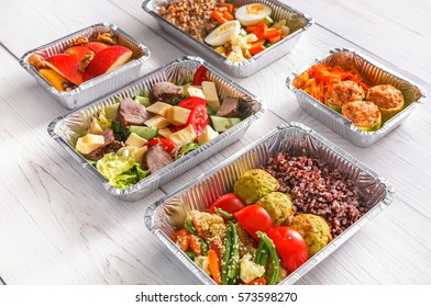 Healthy Restaurant Food. Chef Prepared Diet Daily Meals Delivery. Fitness Nutrition, Vegetables, Meat And Fruits In Foil Boxes, Cutlery In Craft Package On Wood