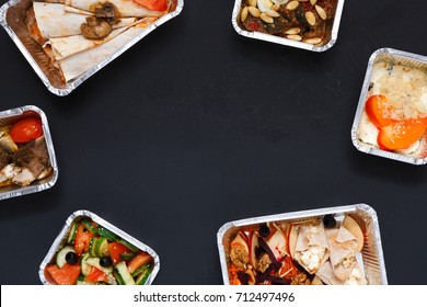 Healthy restaurant food delivery background with copy space. Mockup for menu, foil containers with meals on black