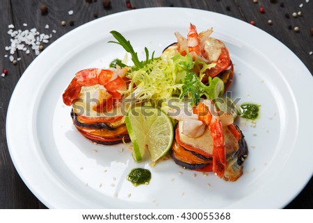 Healthy restaurant food. Ratatoille with cheese and shrimp. Seafood vegetarian vegetable carpaccio. Healthy, right eating food, restaurant french cuisine. Dish at white plate closeup