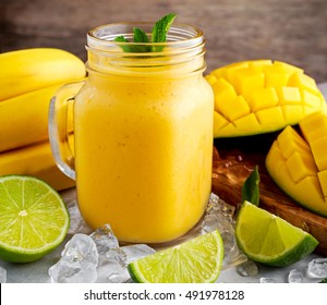 Healthy ripe Yellow Pineapple, coconut, Smoothie with slices of Lime and ice. concept healthy food.