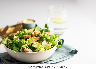 Healthy salad bowl with  different  lettuce, chicken, cheese and croutons  on the table in reataurant.  - Shutterstock ID 1976798645