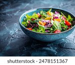 Healthy salad in modrn ceramic bowl on dark slate table
