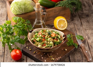 Healthy salad with mung beans, tomatoes, cucumber, lettuce and greens