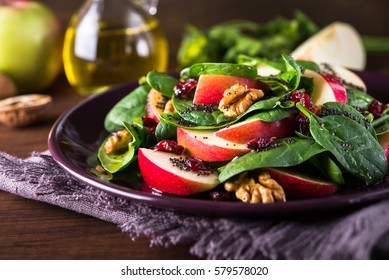 Healthy Salad Plate With Apple, Dried Cranberry, Walnut, Spinach And Poppy Seed Dressing On Wooden Background Close Up. Healthy Food. Clean Eating.