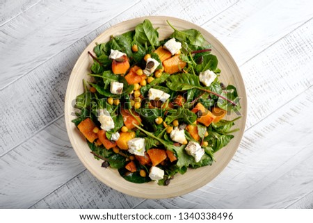 Healthy salad with pumpkin and spinach