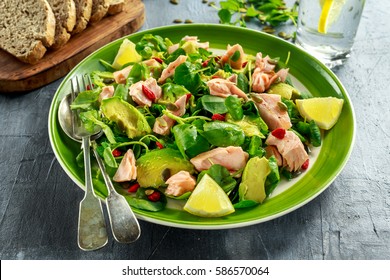 Healthy Salmon, Avocado Salad With Watercress And Goji Berries, Pumpkin Seed Mix On Green Plate