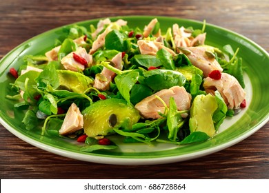 Healthy Salmon, Avocado Salad With Watercress And Goji Berries, Pumpkin Seed Mix On Green Plate