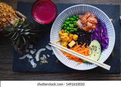 Healthy Salmon Poke Bowl, Fresh Food And Raw Ingredients. Poke Bowl Made With Edamame Beans, Pineapple, Carrots, Slaw And Black Rice