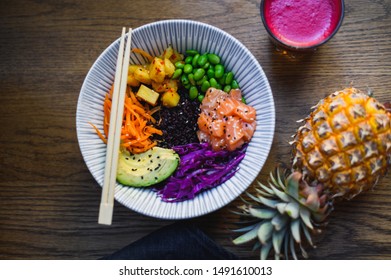 Healthy Salmon Poke Bowl, Fresh Food And Raw Ingredients. Poke Bowl Made With Edamame Beans, Pineapple, Carrots, Slaw And Black Rice