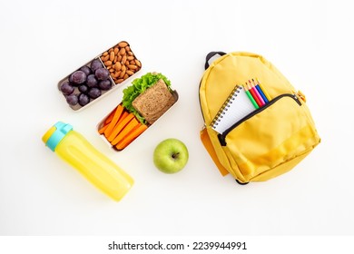 Healthy school lunch box with fruits and backpack, top view - Powered by Shutterstock