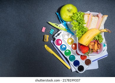 Healthy School Lunch Box: Sandwich, Vegetables, Fruit, Nuts And Yogurt With School Kids Supplies, Accessories And Backpack On Black Background Flatlay Copy Space. Back To School Concept