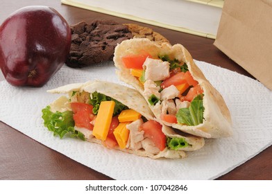 A Healthy School Or Sack Lunch With A Chicken Pita Sandwich, Apple And Cookies