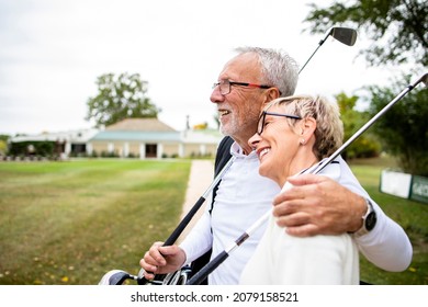 Healthy senior couple in embrace feeling happy and preparing for golf training.