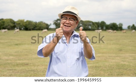Healthy senior man presenting himself happily enjoying holiday with family.
