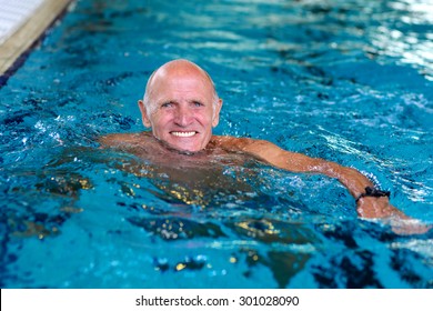 Healthy senior man swimming in the pool. Happy pensioner enjoying sportive lifestyle. Active retirement concept. - Powered by Shutterstock